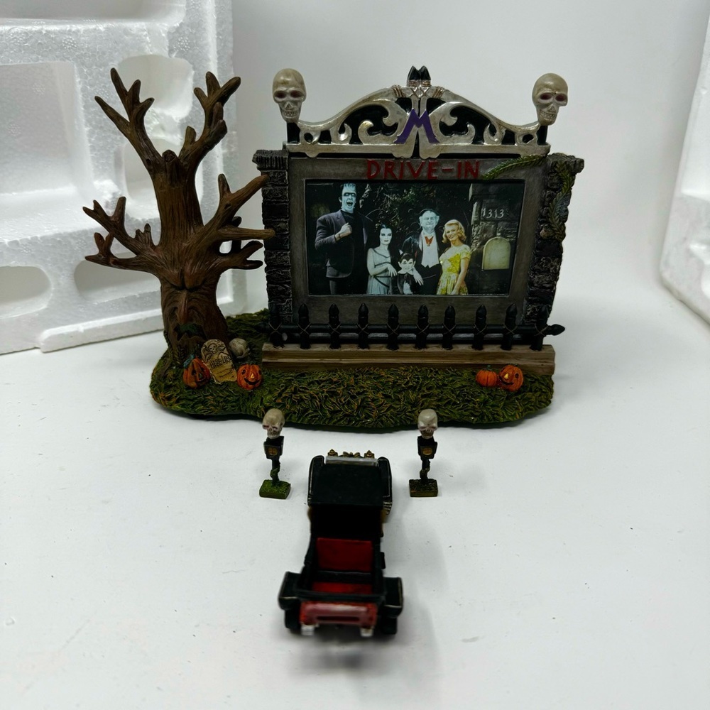 Spooky Drive-In Halloween Scene with Tree and Car